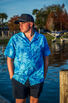 seaplane pilot wearing blue hawaiian print shirt